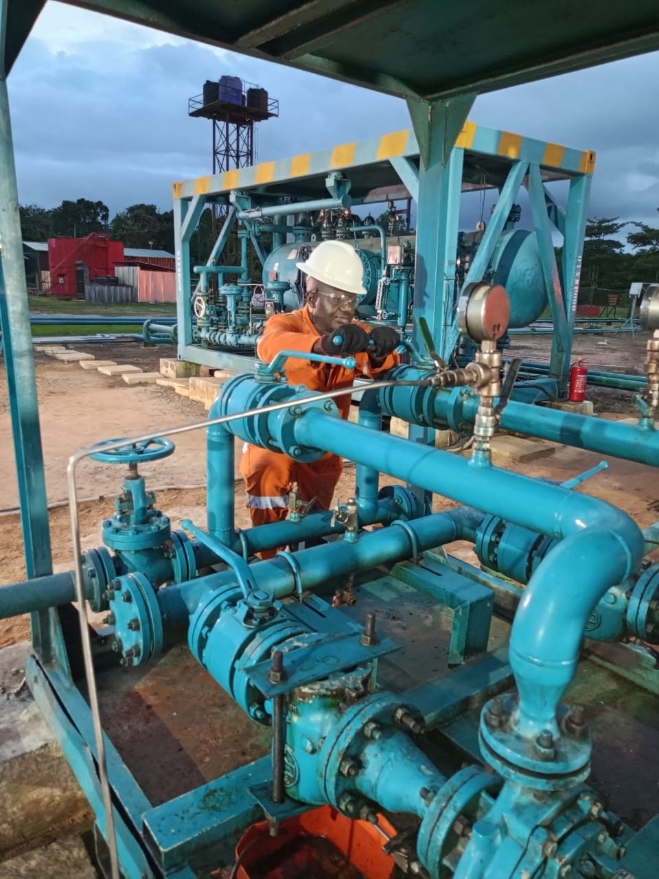 Technician operating oil and gas process equipment